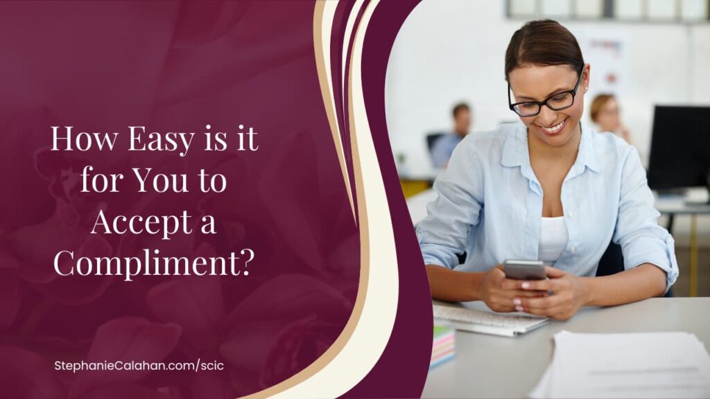 How well can you accept a complement? woman with dark hair and glasses smiling while looking at her phone