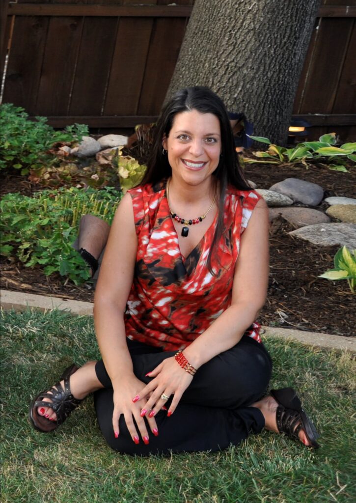 Stephanie Calahan sitting in front of a tree